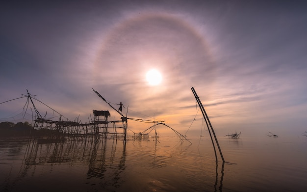 Fishermen are fishing early in the lake.