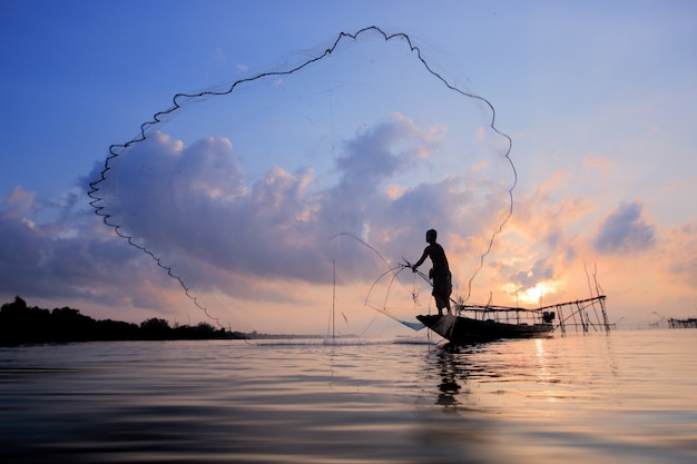 Fishermen on boat fishing with a fishnet