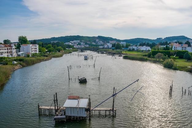 Fishermen catch fish in the huts built on the water