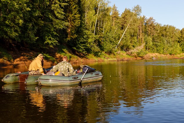 Fishermen catch fish with a rubber boat