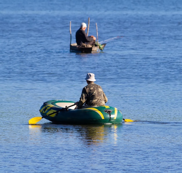 Fishermen fishing in boats in the middle of the river