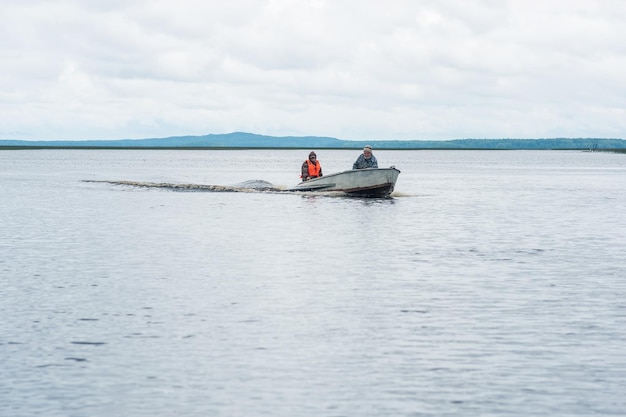 fishermen on a motorboat ride across a wide lake