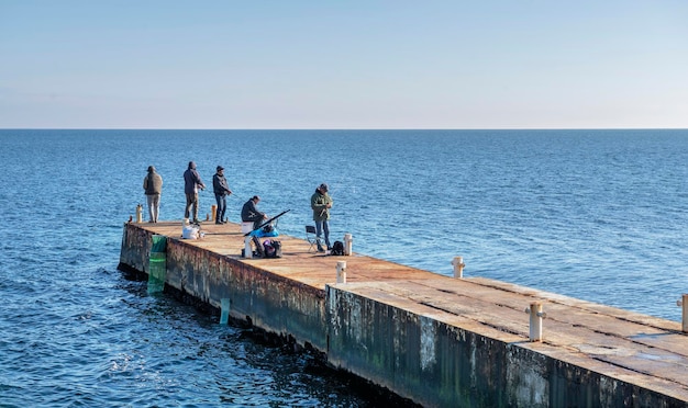 Fishermen on the pier in Odessa Ukraine