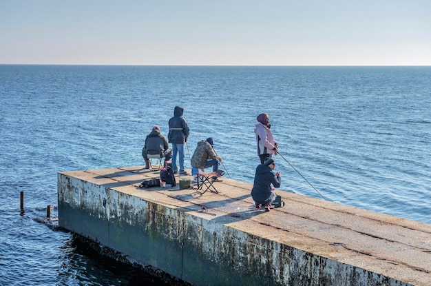 Fishermen on the pier in Odessa Ukraine