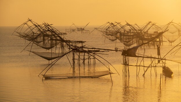 Fishermen use fishing net trap catch fish in the morning