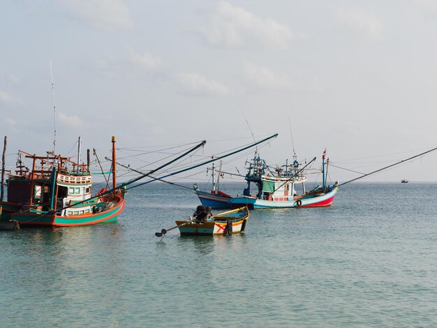 Fishing boat anchored against a clear sky