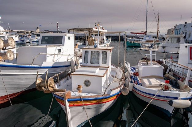 Photo fishing boat anchored at naousa old harbor paros island greece cyclades summer holiday