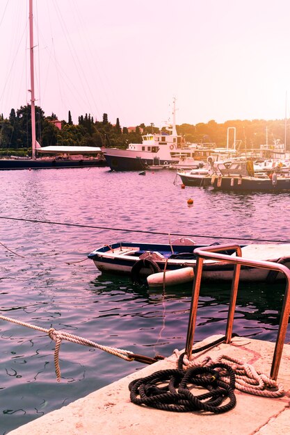 Fishing boat on the dock, ropes and pillar close-up - travel background.