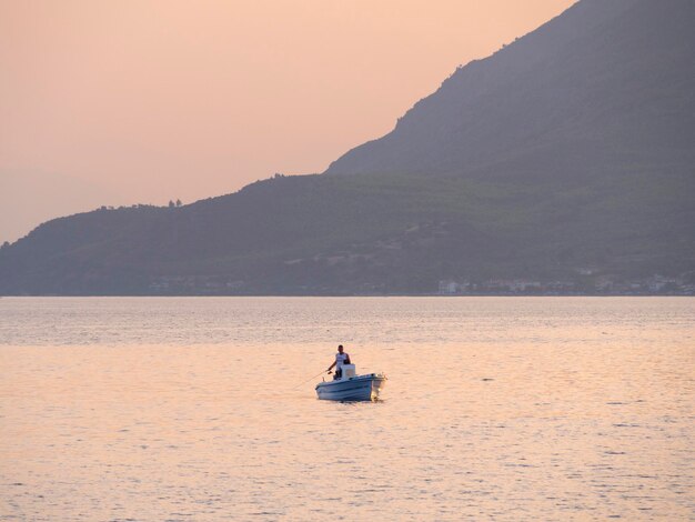 Fishing boat and fishing at sunset in the Aegean Sea near the island of Evia in Greece