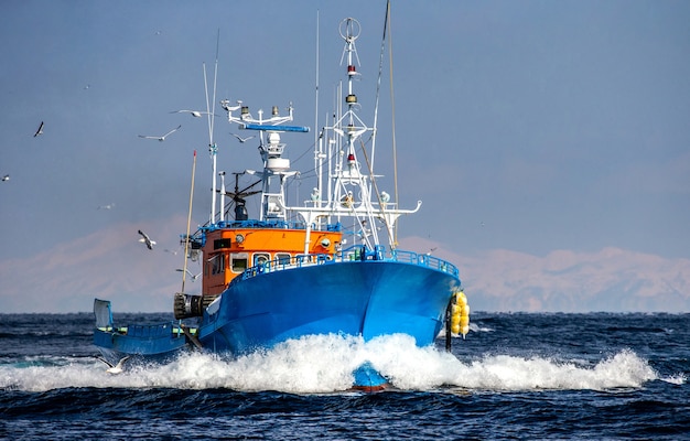 Fishing boat is returning after fishing to its port