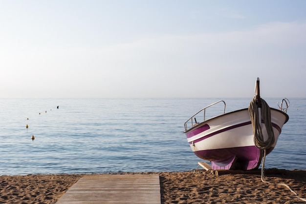 Fishing boat on the sand seashore