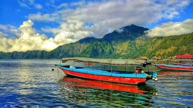 Fishing boat in sea against sky