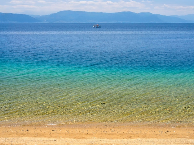 Fishing boat in sea of Greek spa resort of Loutra Edipsou on island of Evia Euboea Greece