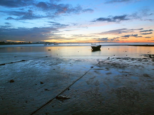 Fishing boat in the sea at sunrise