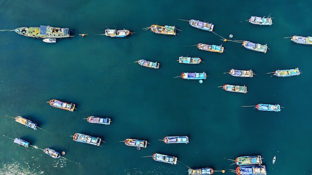 Fishing boats on the cyan sea. Aerial panoramic view
