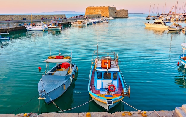 Fishing boats in the harbour near the Venetian Fortress in Heraklion, Crete, Greece