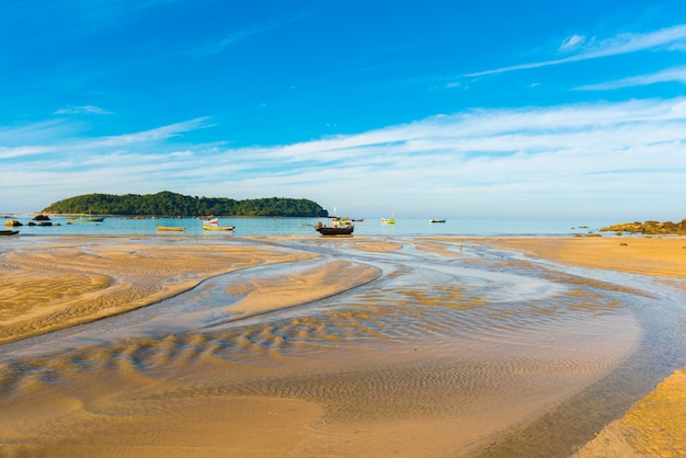 Fishing boats at low tide on the beach, Ngapali, Myanmar. Copy space for text