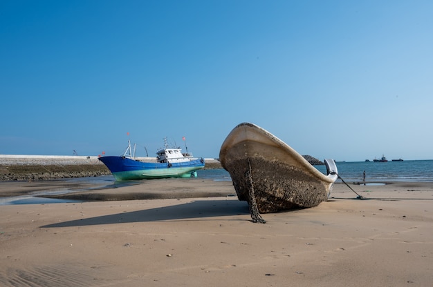 Fishing boats stranded on the beach after low tide