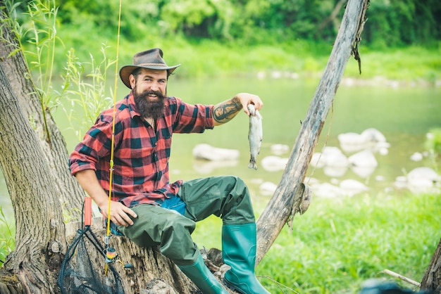 Fishing hobby and summer weekend bearded men fisher with fishing rod