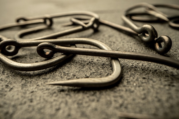 Photo fishing hooks on concrete textured background