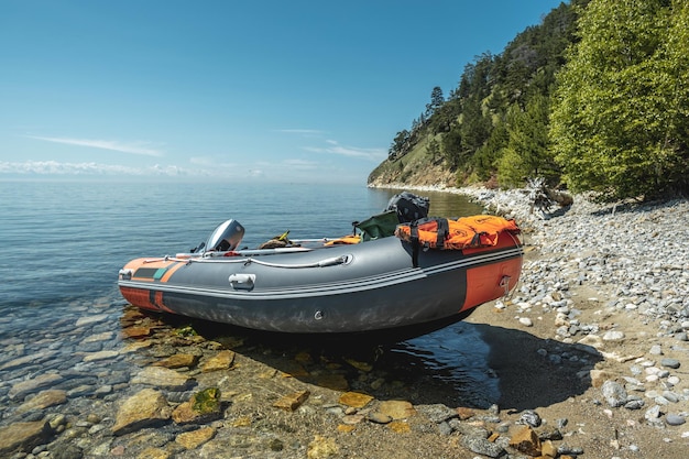 Fishing motor boat on the shore of Lake Baikal A summer landscape of unique nature
