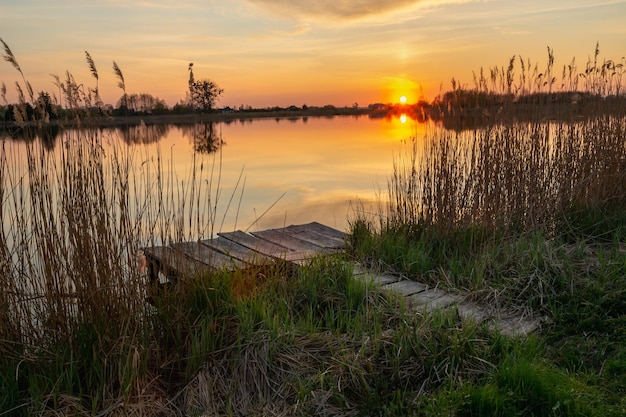 Fishing pier on the shore of the lake and sunset Stankow Poland