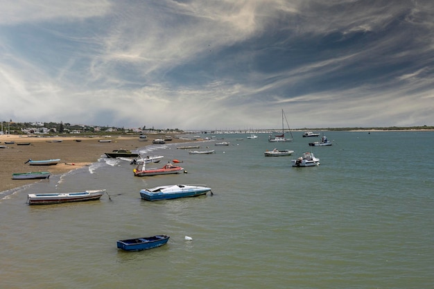 Fishing and pleasure boats anchored on the banks of a river