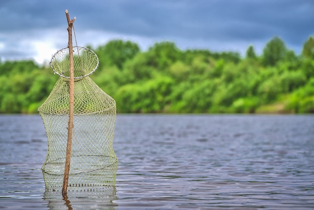 A fishing pond is a fish trap a device for storing caught fish during fishing