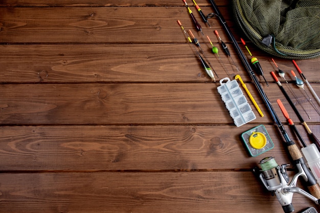 Fishing rod fishing float and accessories on wooden