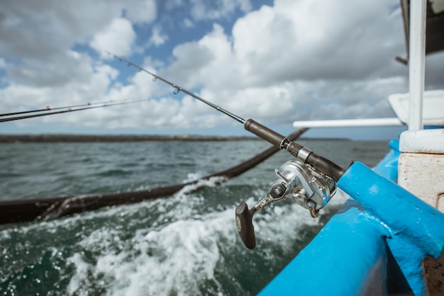 Premium Photo  Fishing rod mounted on a small fishing boat while