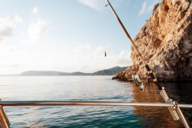 Fishing rod on a sailboat on the background of the sea