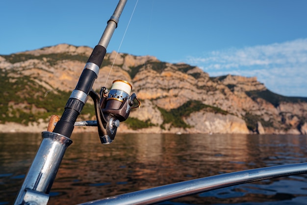 Fishing rod on a sailboat in open sea, close up photo