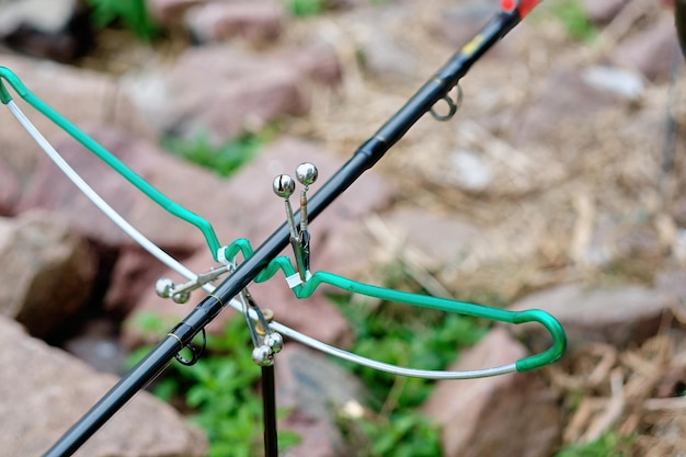 Fishing rod on a stand with a bell for signaling biting Closeup