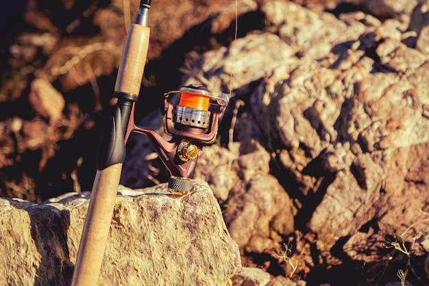 Photo fishing rod with reel at the seashore