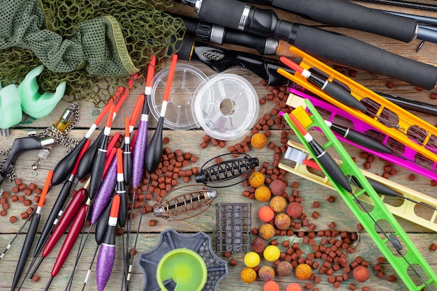 Fishing rods and spinnings in the composition with accessories for fishing on the old surface on the table