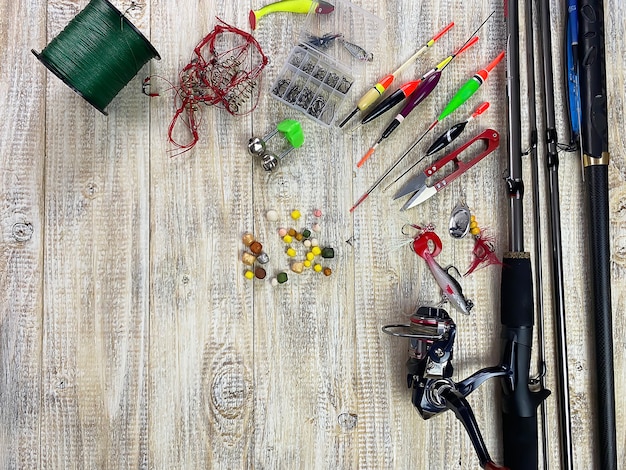 Fishing tackle. Float, wobbler, bait hooks, on a wooden background. Selective focus