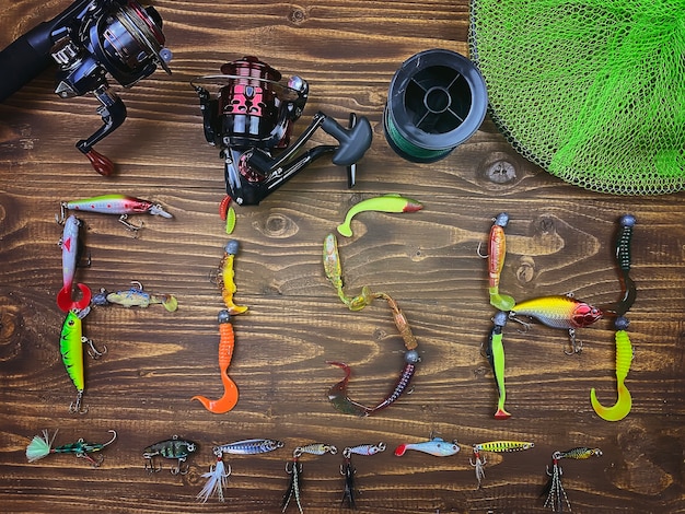 Fishing tackle. Float, wobbler, bait hooks, on a wooden surface. Selective focus