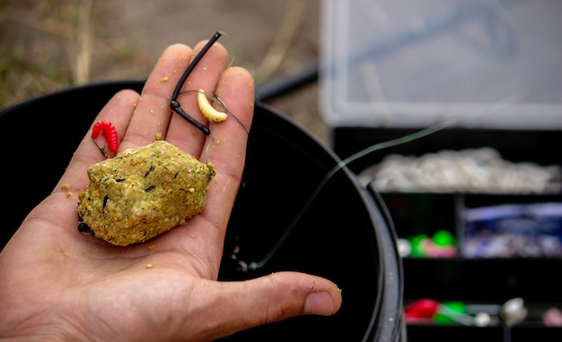 Fishing tackle on a wooden float with mountain background and selective focus, nature