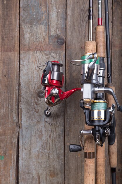 Fishing tackles on old wooden board