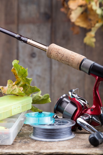 Premium Photo  Fishing tackles on old wooden board