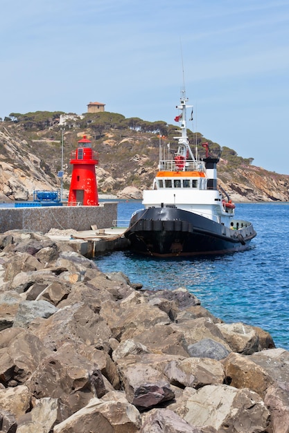 Fishing Trawler and Small Red Lighthouse