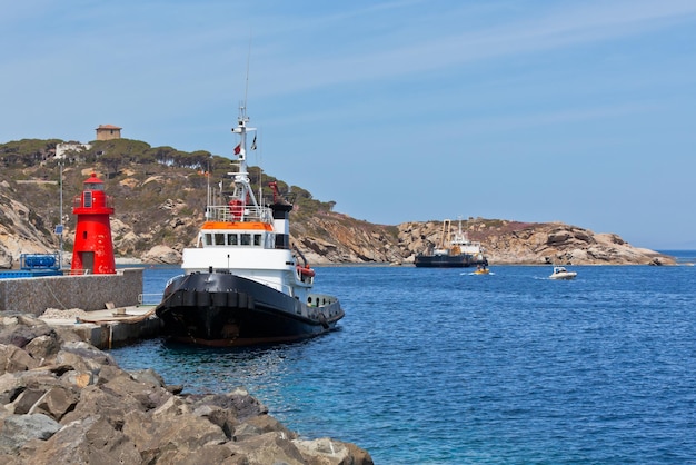 Fishing Trawlers and Small Red Lighthouse