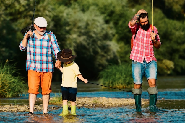 Fishing with son and grandson grandfather and father with cute child boy are fishing