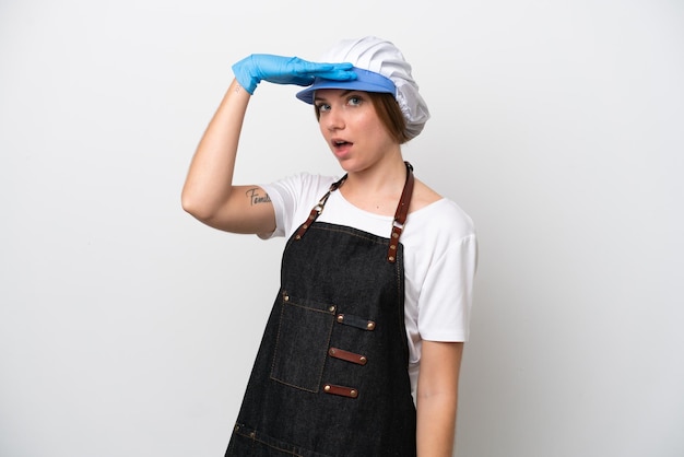 Fishmonger woman wearing an apron doing surprise gesture while looking to the side