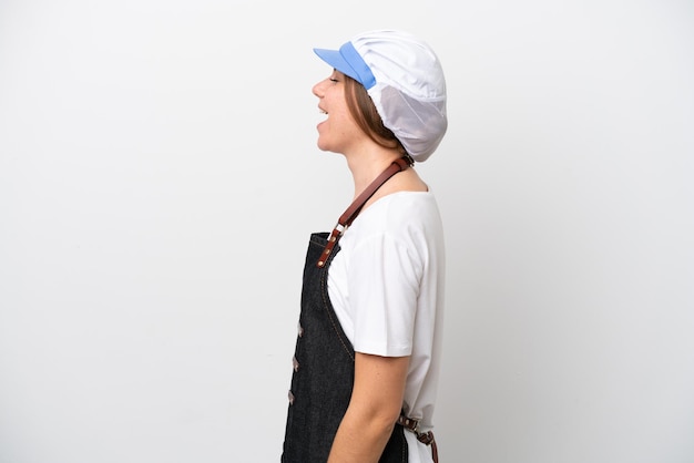 Fishmonger woman wearing an apron laughing in lateral position