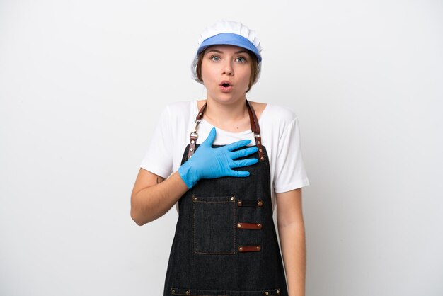 Fishmonger woman wearing an apron surprised and shocked while looking right