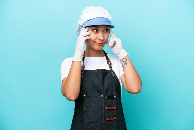 Fishwife Argentinian woman isolated on blue background having doubts and thinking