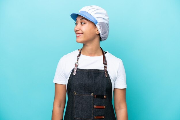 Fishwife Argentinian woman isolated on blue background looking side