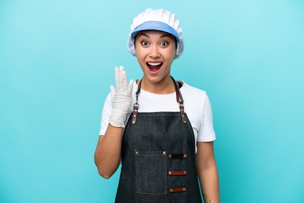 Fishwife Argentinian woman isolated on blue background with surprise and shocked facial expression