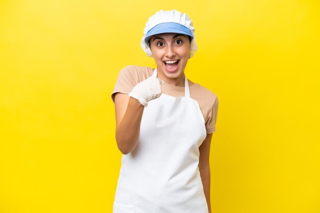 Fishwife woman over isolated background with surprise facial expression